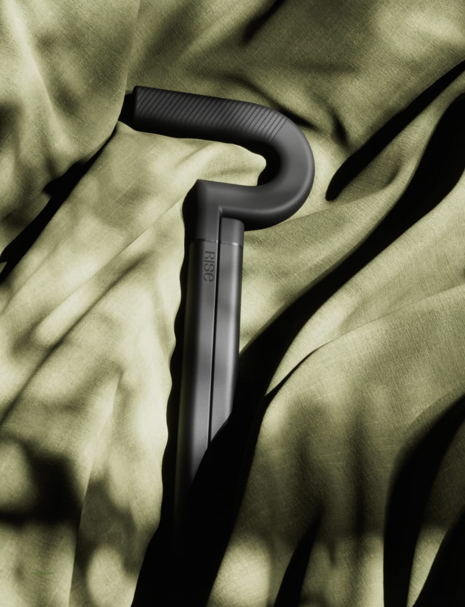 The folded Rise cane resting on olive linen